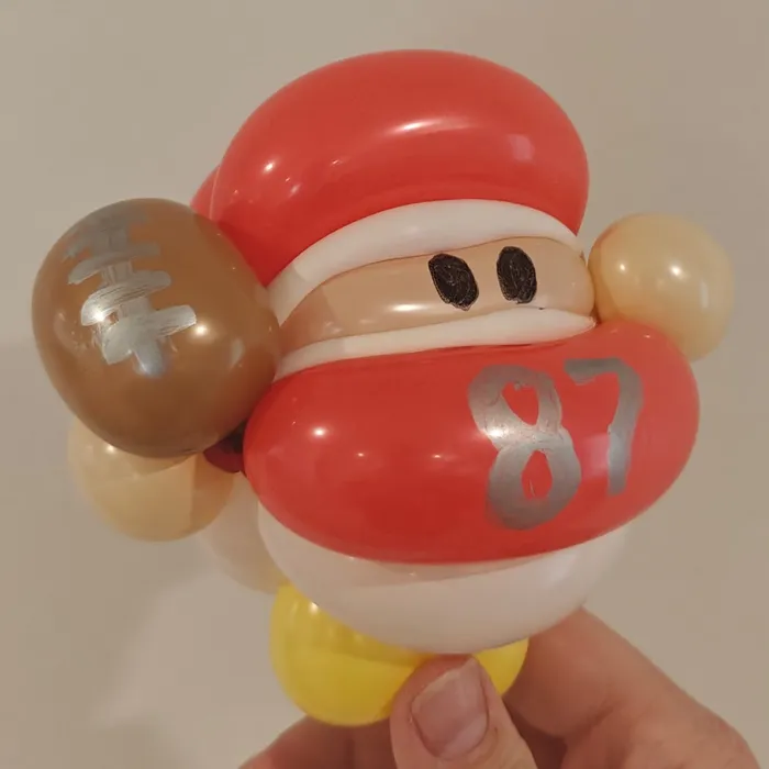 Balloon football player character with a number 87 jersey