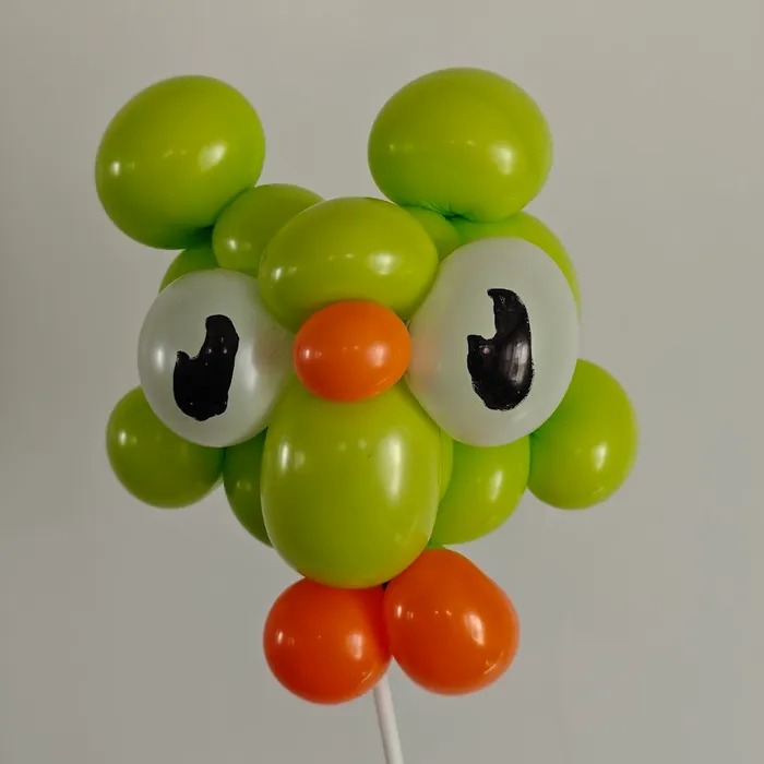 Green and orange balloon owl character